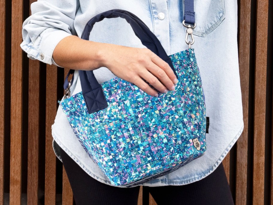 woman with a blue printed crossbody tote bag