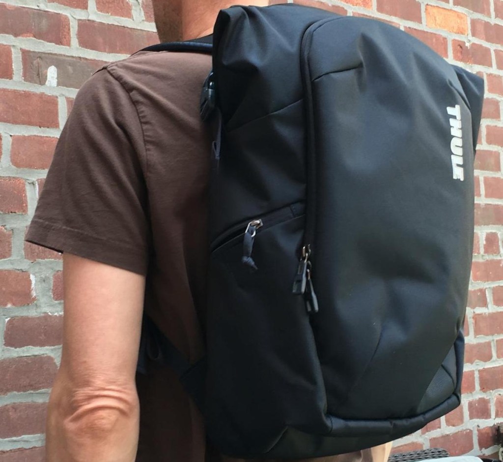 man wearing a thule backpack