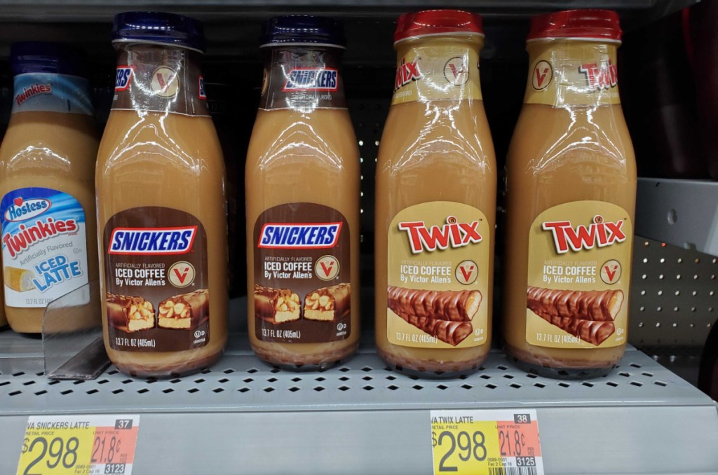 bottles of hostess and victor allen iced coffee flavors lined up on a walmart store shelf