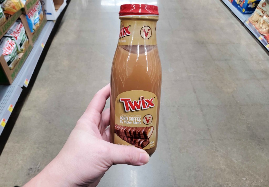 bottle of twix flavored victor allen iced coffee held in hand in a store aisle