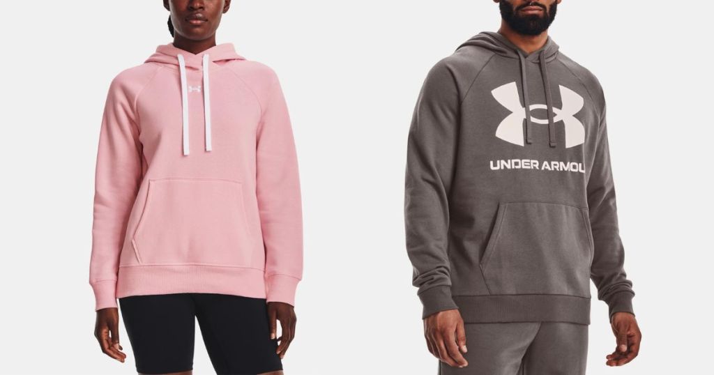 woman wearing pink hoodie with white Under Armour logo and man wearing gray hoodie with white under armor logo and print