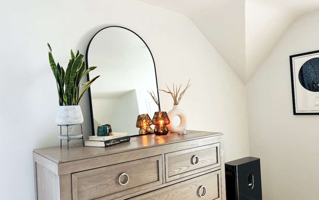 dresser with black arch mirror plant and mushroom lamp how to hang pictures without nails