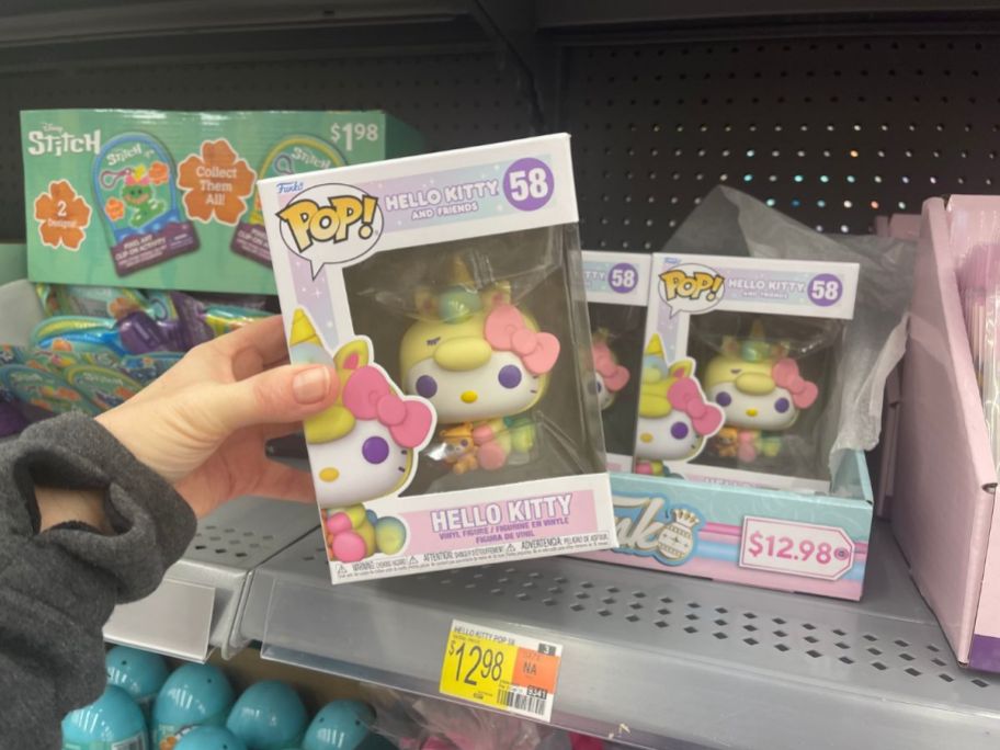 hand holding a Hello Kitty Unicorn Funko Pop at Walmart