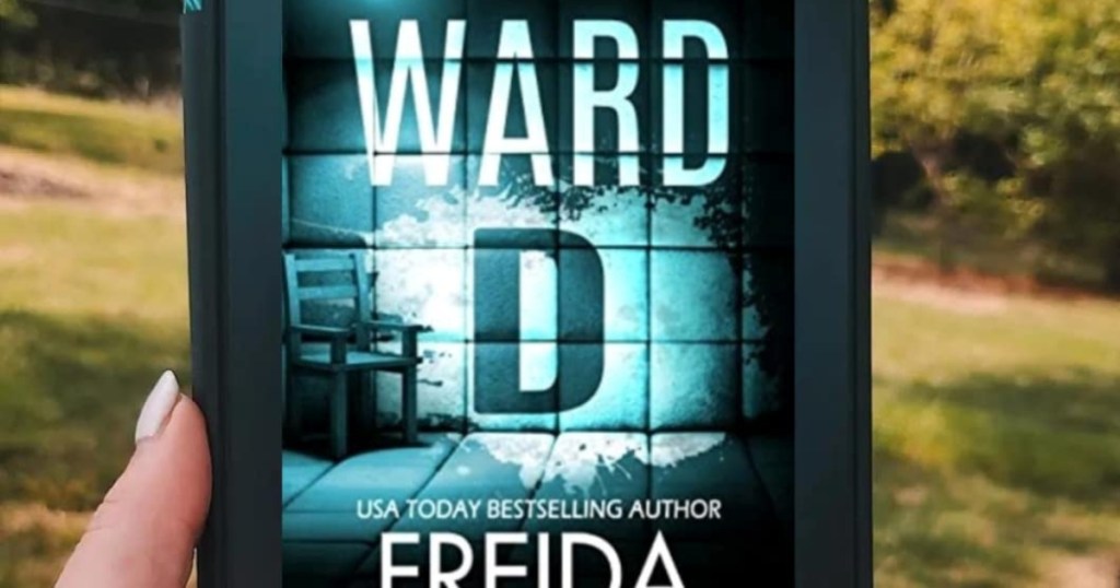 holding a Kindle with Ward D's cover on it