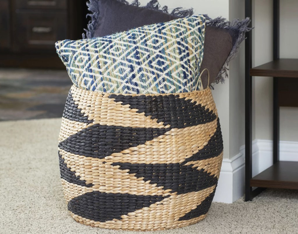 throw pillows in a large basket with a zig zag print