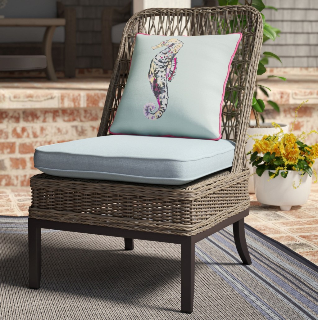 Wicker patio chair with cushion on it