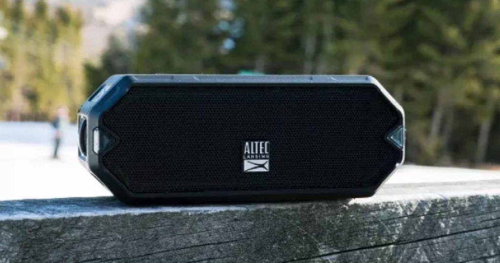 black speaker in front of woods background