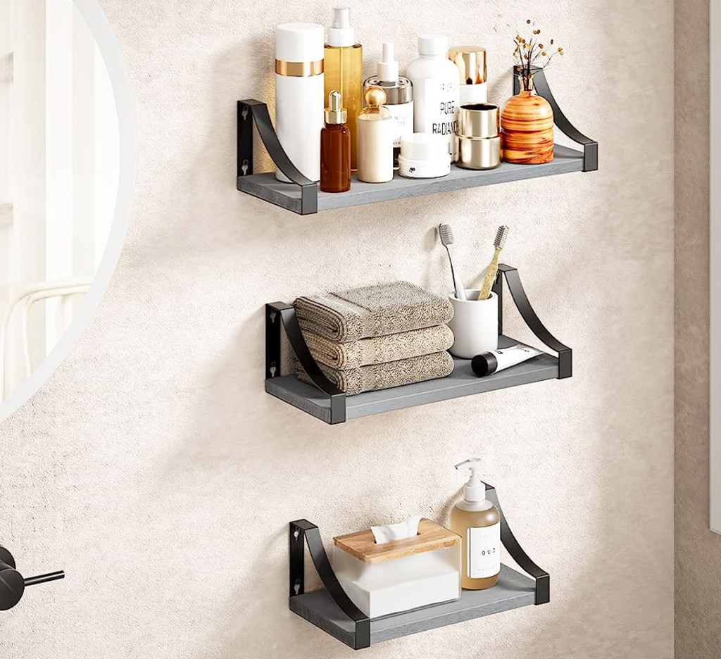 beauty and bathroom items on three grey floating shelves