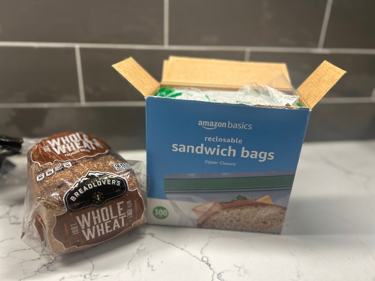 Box of Amazon Basics Sandwich Bags on counter next to loaf of wheat bread