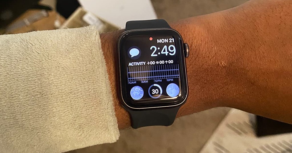 person wearing black apple watch se on their wrist