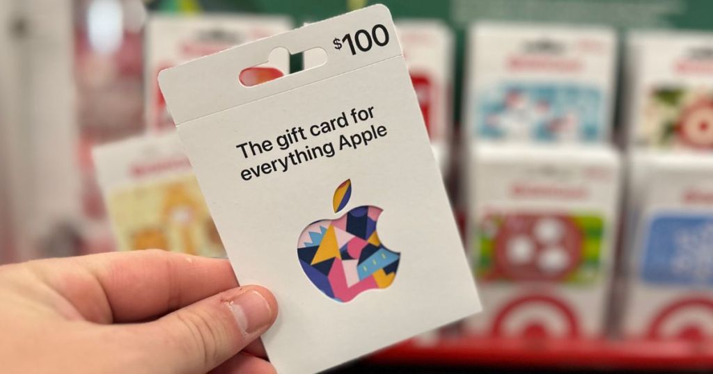 Hand holding an Apple gift card