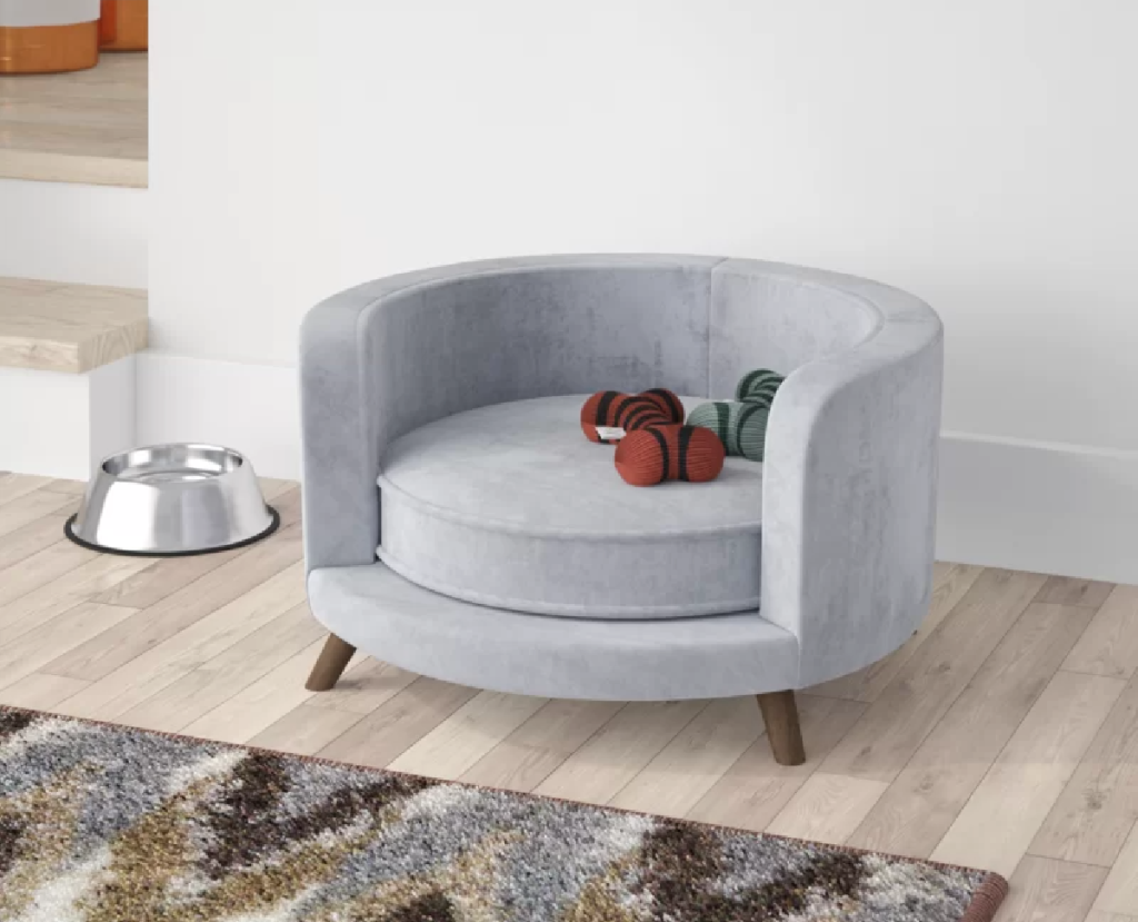 A modern dog couch bed from Wayfair set up in a living room