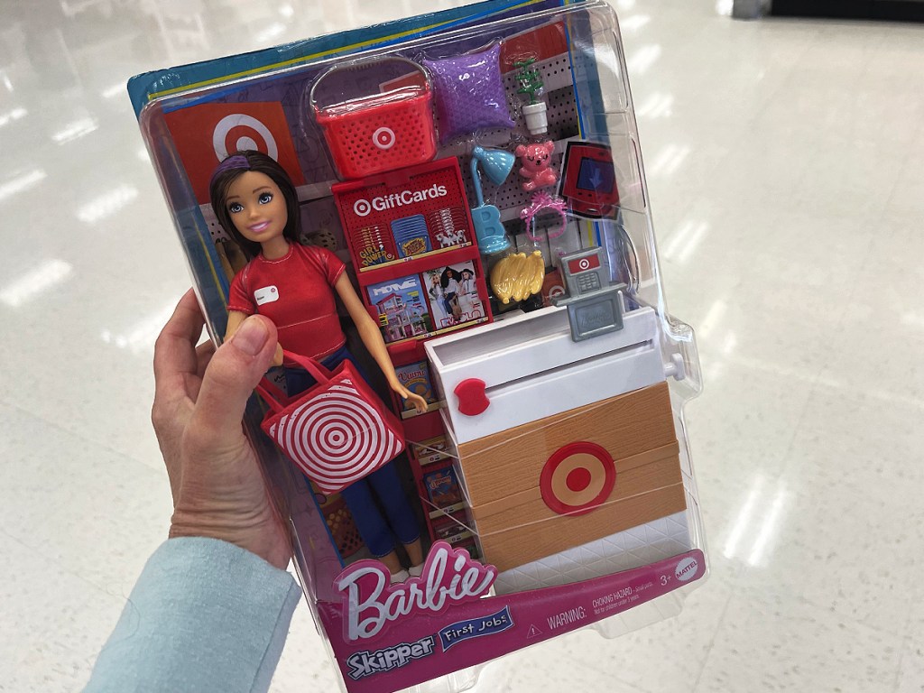 woman holding Barbie Skipper First Job Doll in Target store