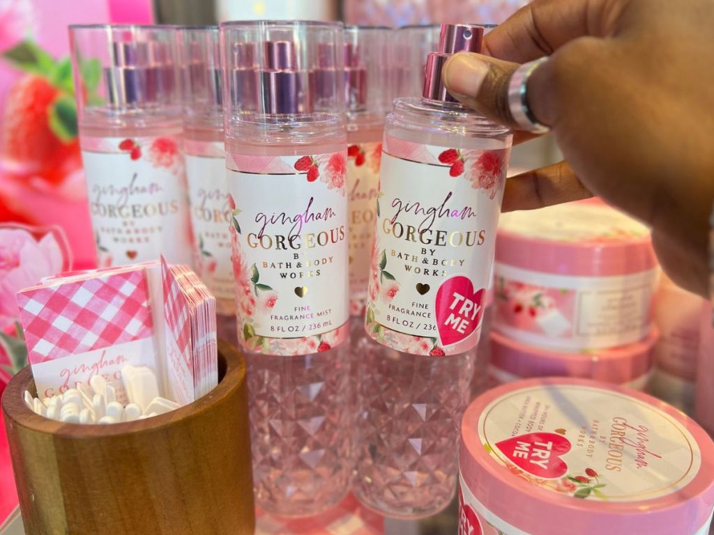 hand tipping a bottle of Bath & Body Works Gingham Gorgeous Fragrance Mists