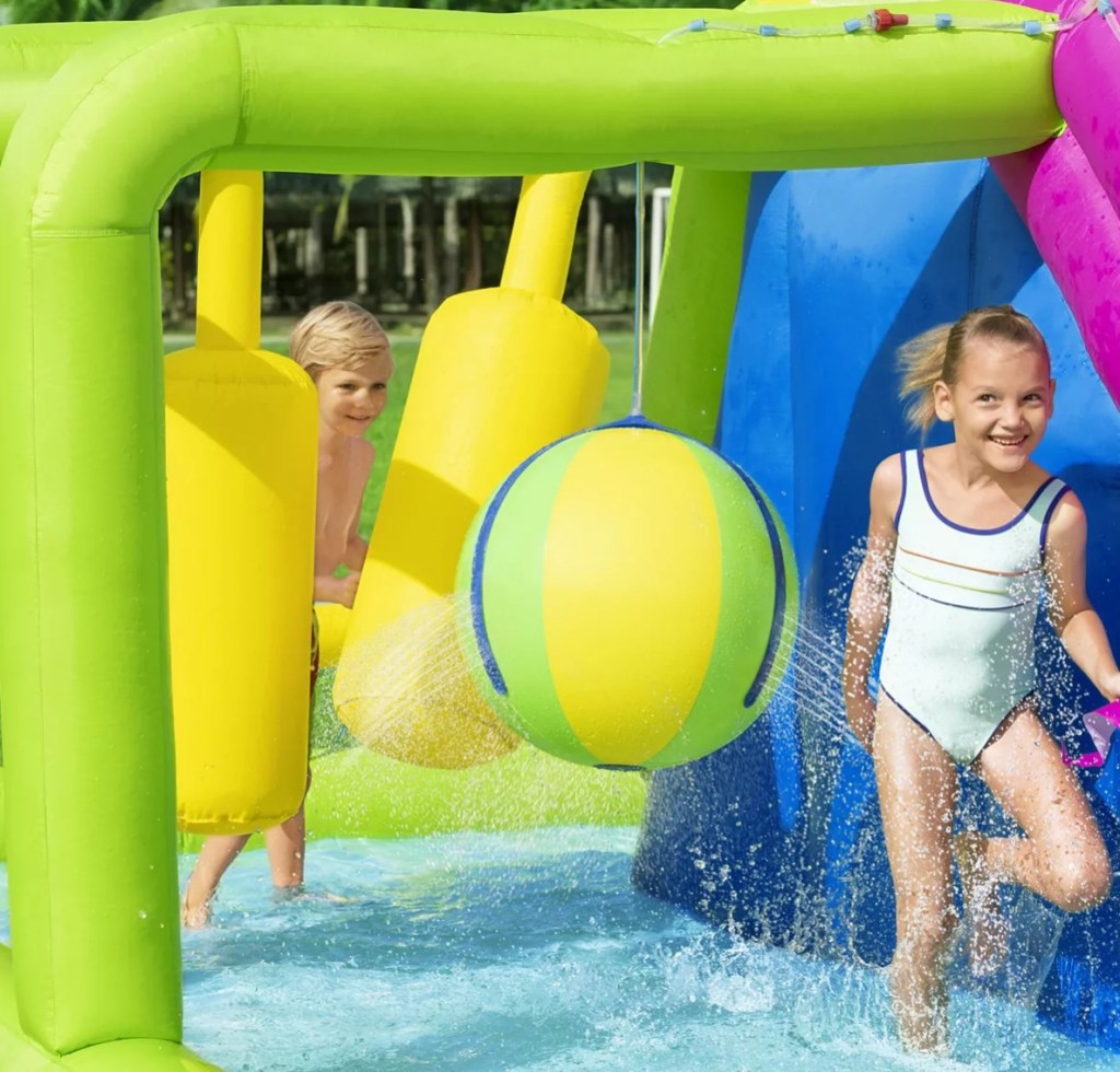 Kids playing on an obstacle course on an inflatable water park