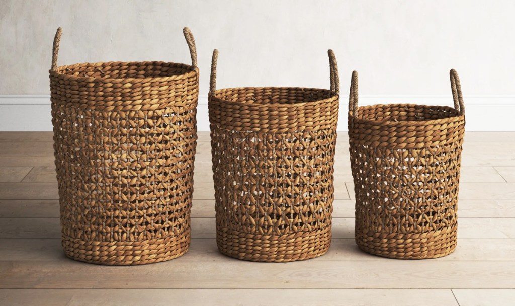 set of 3 tall round brown baskets on wood floor