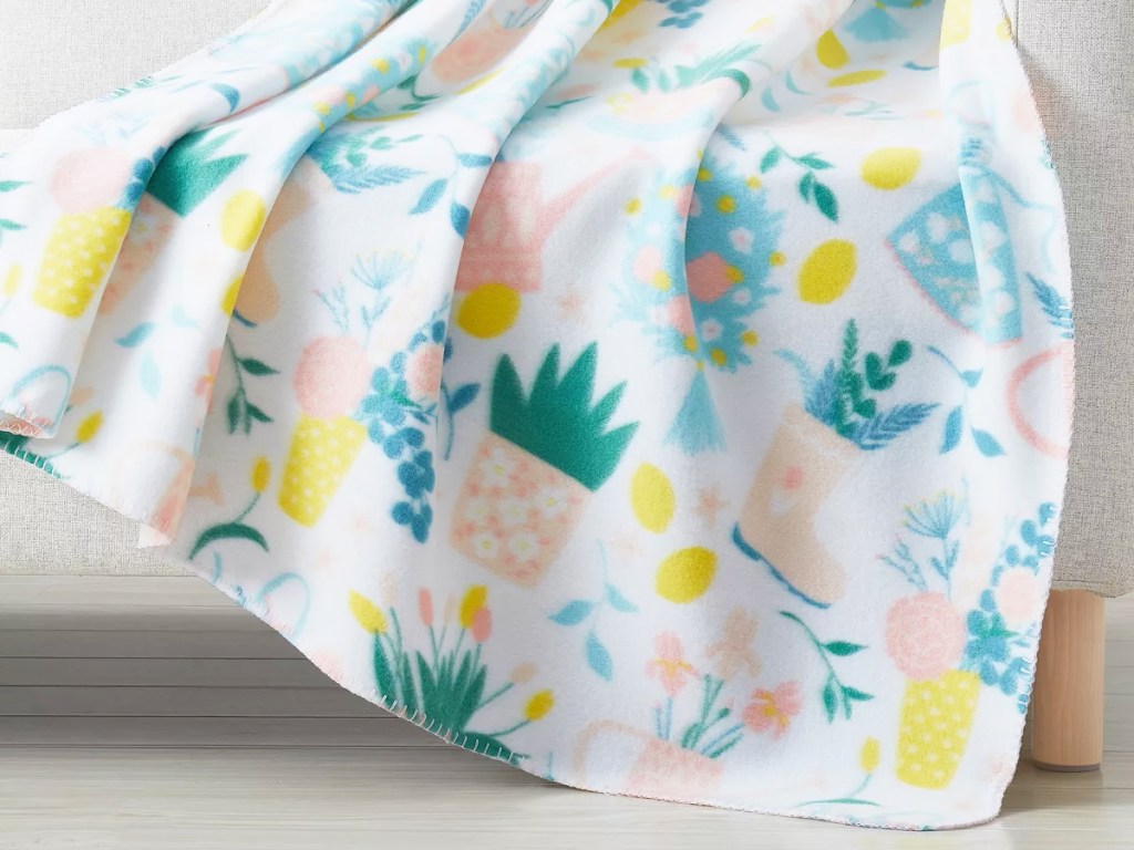 spring print throw blanket draped over couch