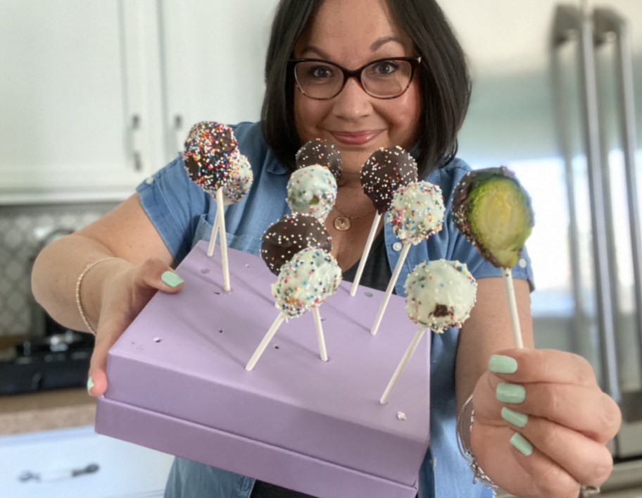 woman holding up prank cake pops for April Fools' Day