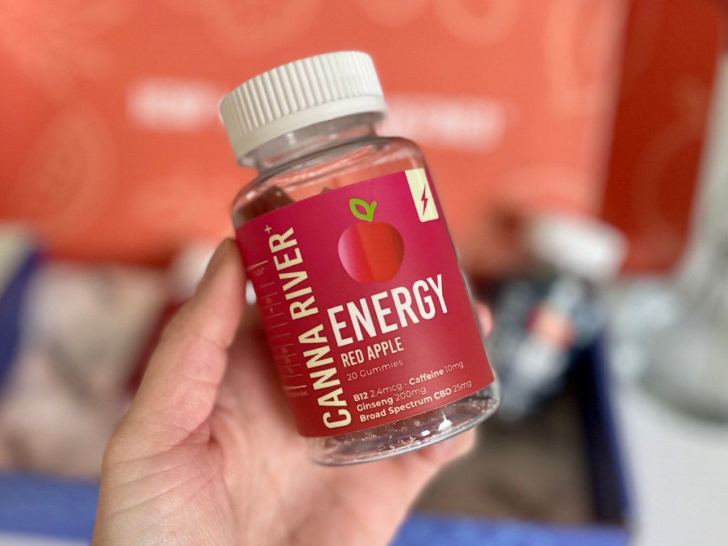 woman holding bottle of CAnna River Energy Gummies