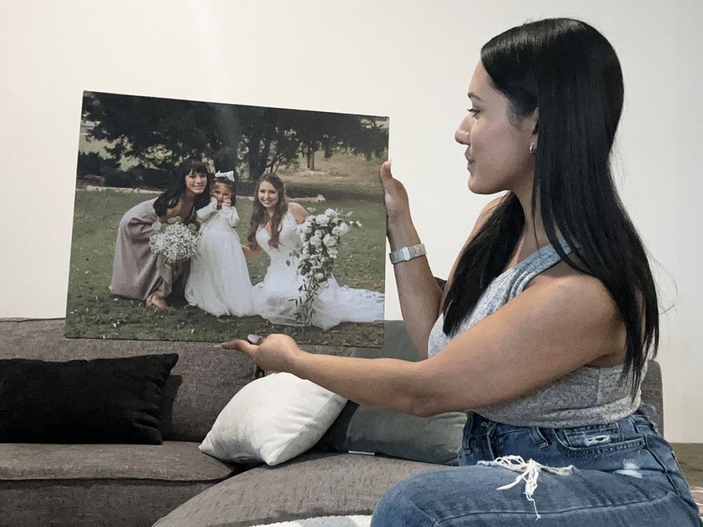 woman holding and looking at a photo canvas