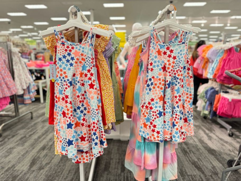 2 Cat & Jack Multicolored Star Dresses on a rack in Target