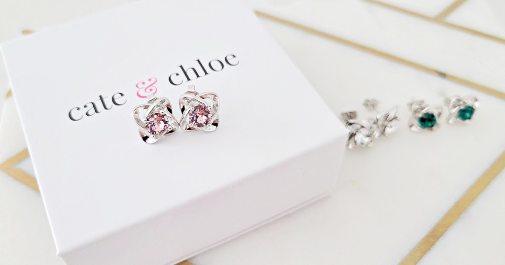 3 different pairs of Cate Chloe Birthstone Earrings displayed next to gift box