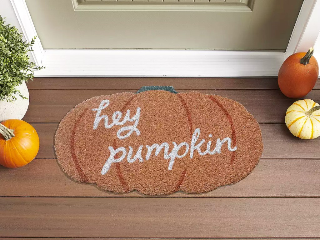 pumpkin shaped doormat that says hey pumpkin