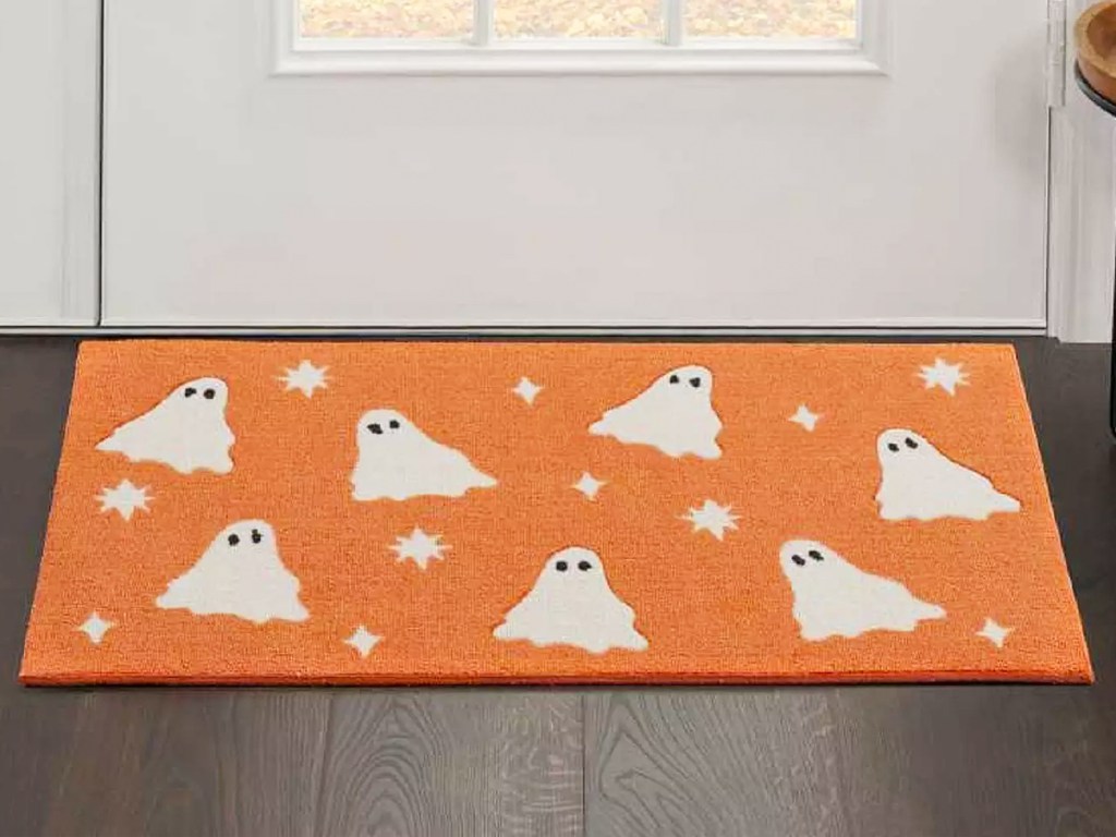 orange accent rug with ghost print