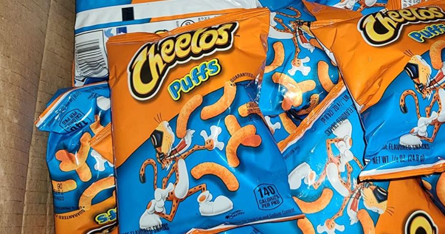 Bags of Cheetos puffs in a box