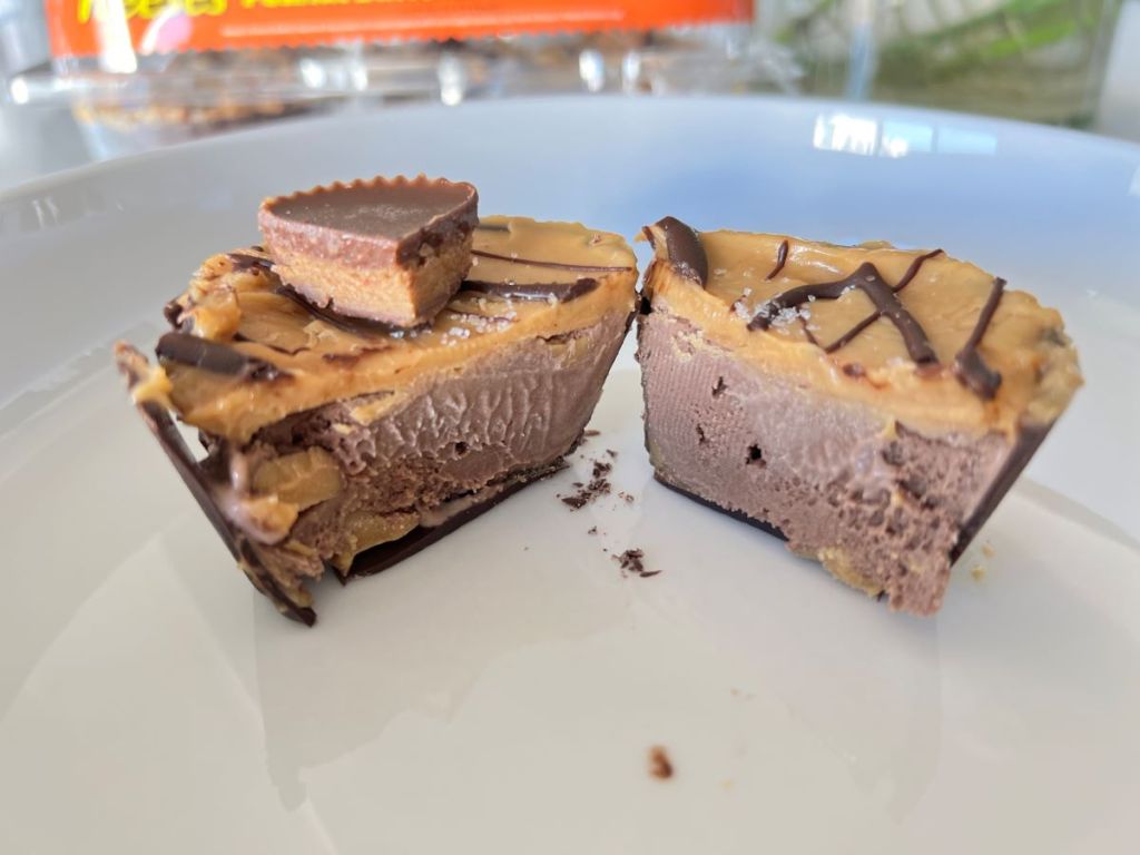 Coldstone Creamery Reese's ice cream cup cut in half on a plate