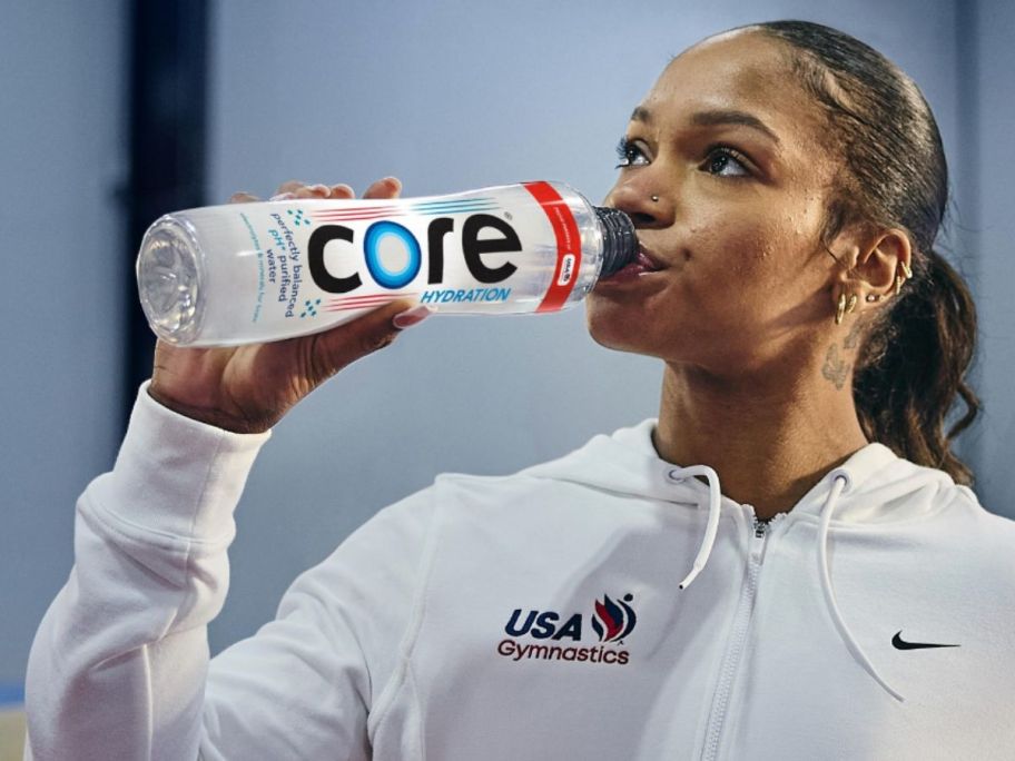 An athlete drinking from a Core water bottle