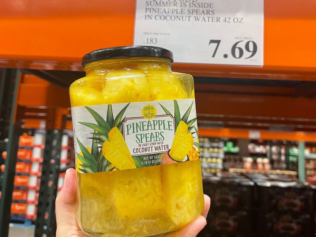 Hand holding up a jar of Pineapple Spears at Costco
