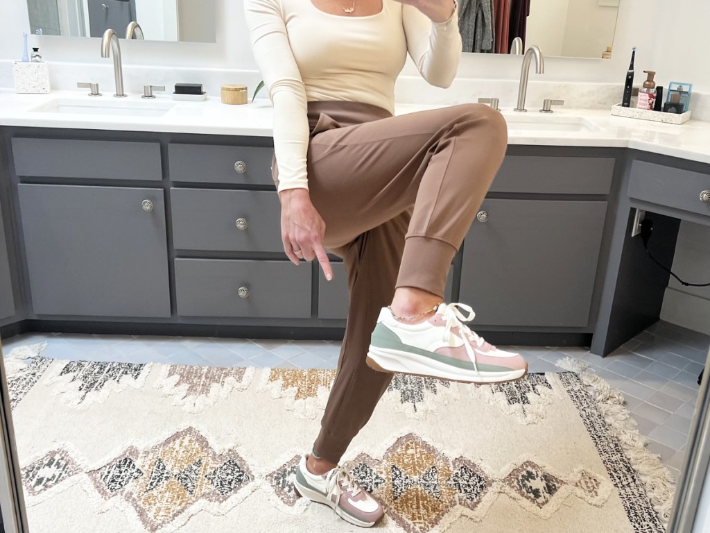 woman taking selfie in mirror pointing at her shoes