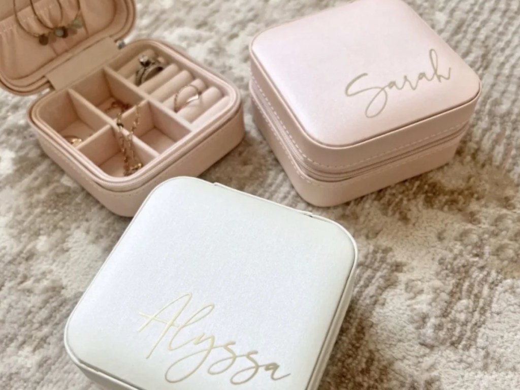 white and blush colored jewelry boxes with names in cursive across cover