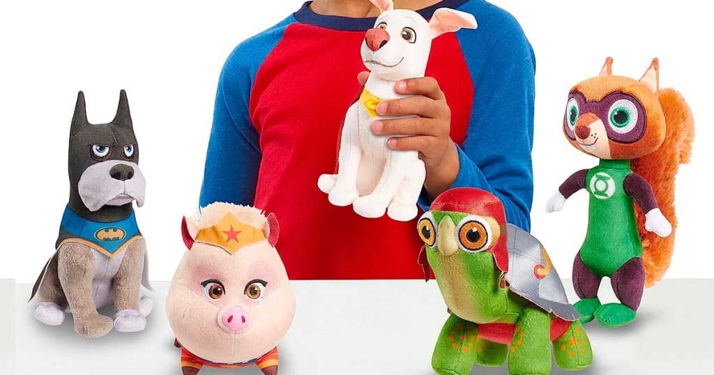 child playing with dc super pets plush toys two dogs, pig, turtle and squirrel