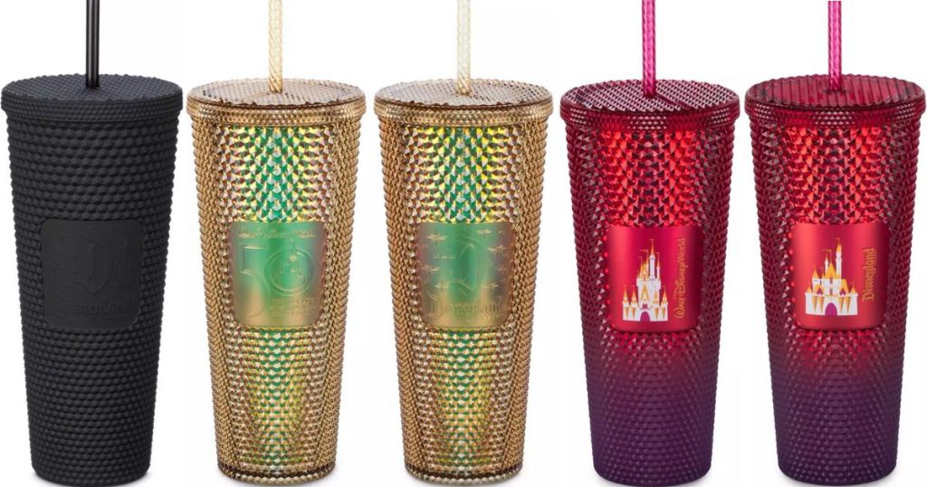 Five Disney Starbucks tumblers, one in black, two in gold and two in red