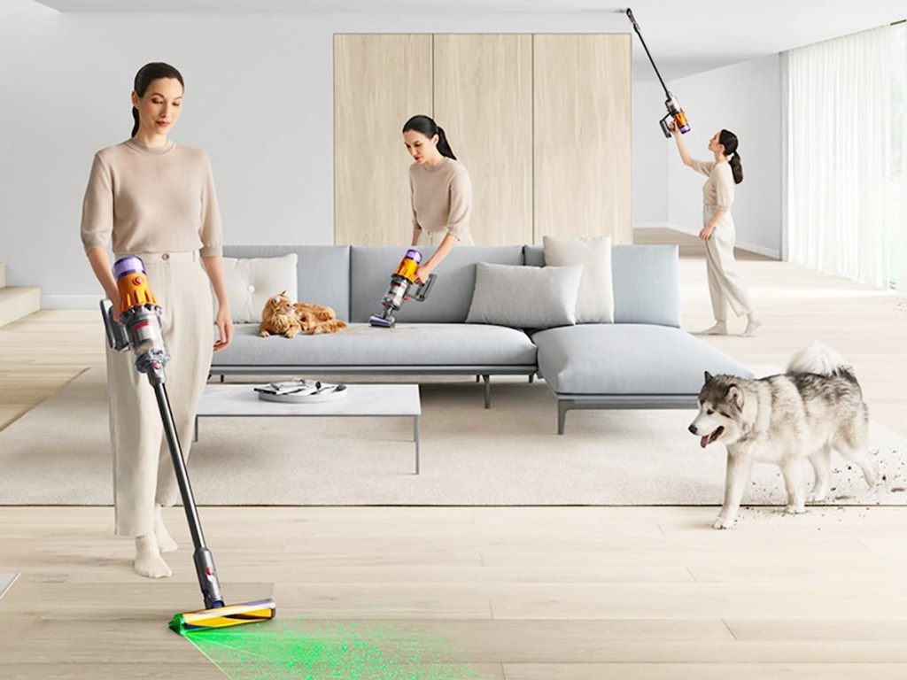 woman cleaning floor, ceiling, and sofa with dyson vacuum