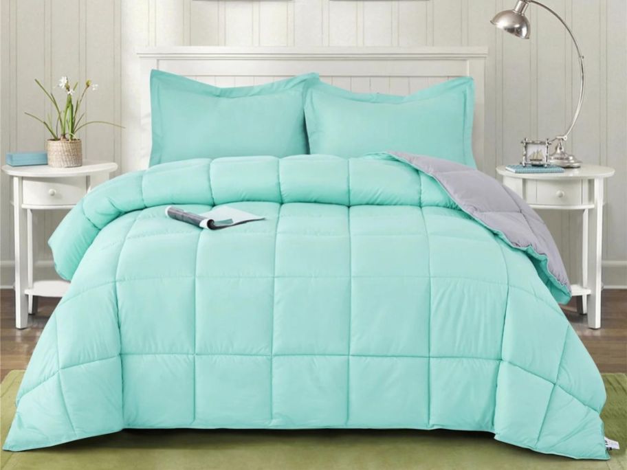 teal comforter set on bed in bedroom