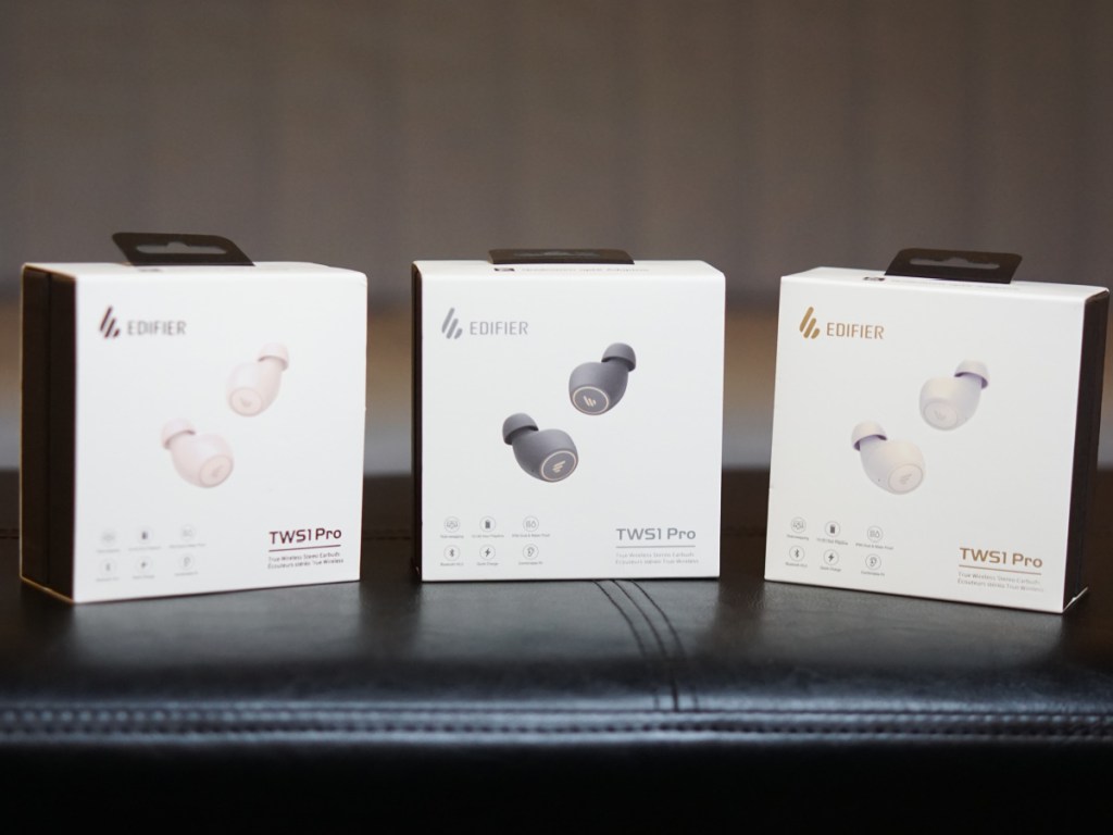 Edifier Pro Earbuds in three different colors sitting on a couch