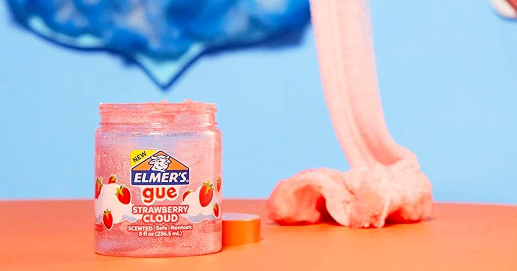 empty jar of Elmer's Gue with pink slime in the background