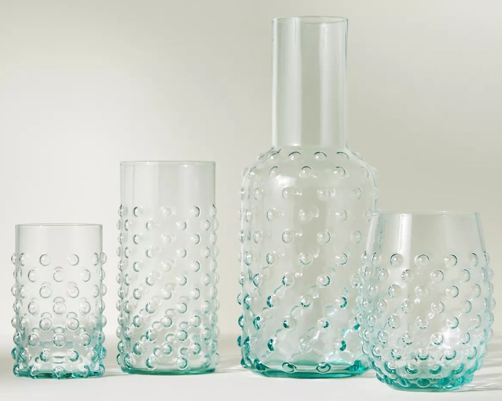 Row of bubbled glasses and carafe