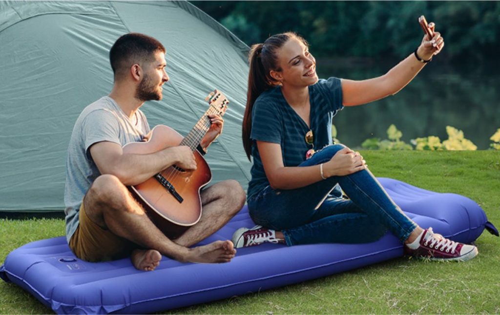 Evajoy Air Mattress with couple sitting on it playing guitar and taking selfies
