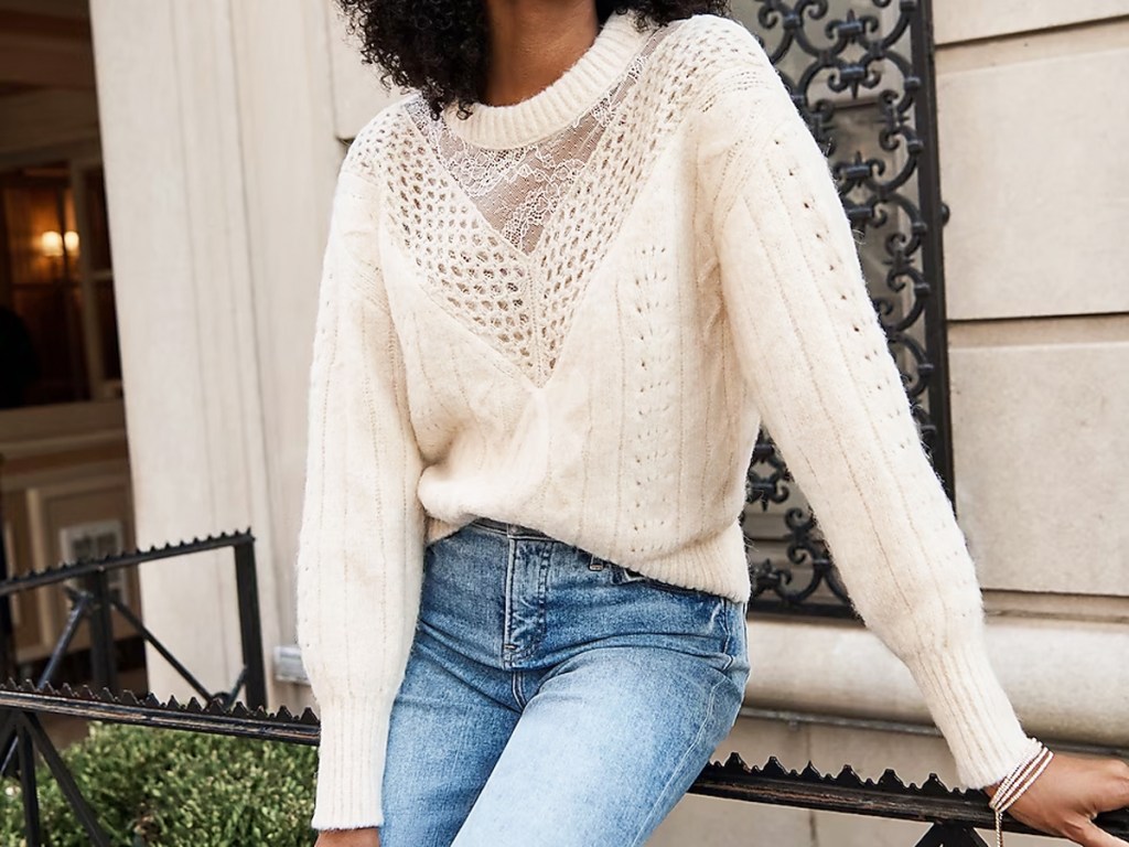 woman in white sweater and jeans