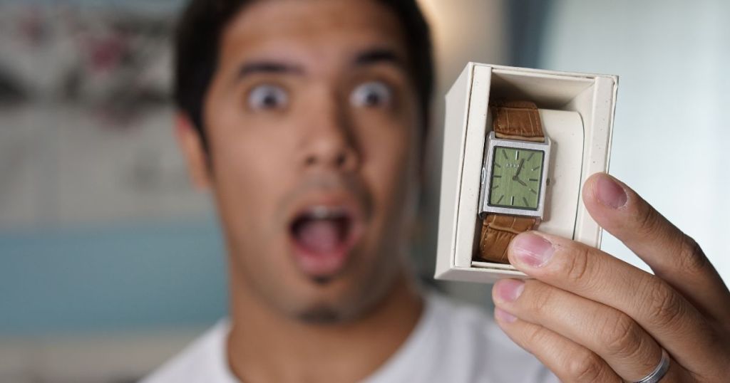 man looking at watch with a shocked face
