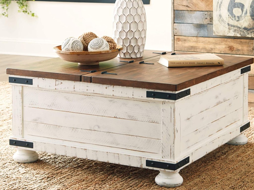 Farmhouse Square Storage Coffee Table with decorations on top of it