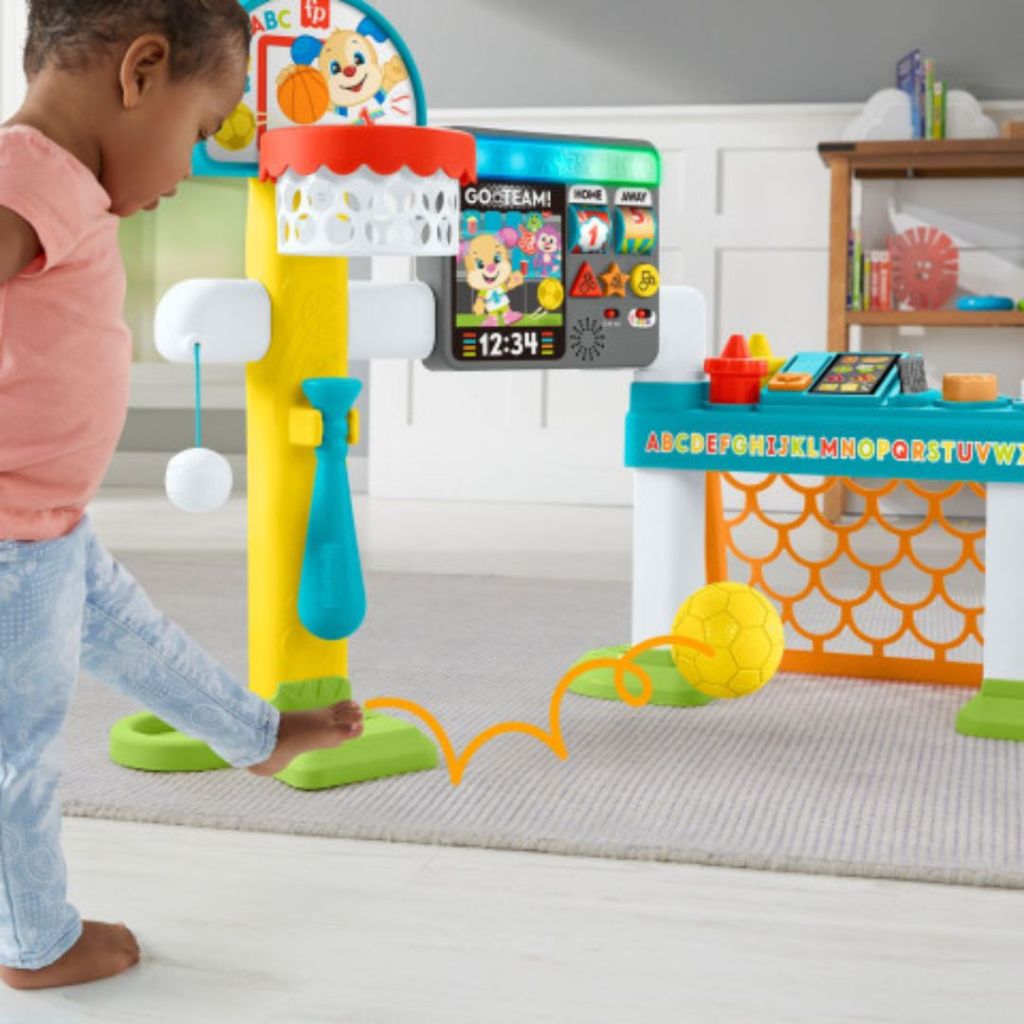 Fisher-Price Laugh & Learn Toddler Learning Toy, 4-In-1 Game Experience Sports Activity Center with little girl playing