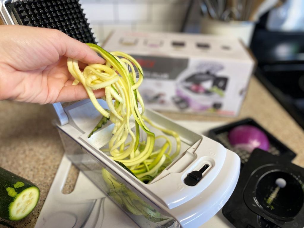 Hand holding spiralized zucchini pieces