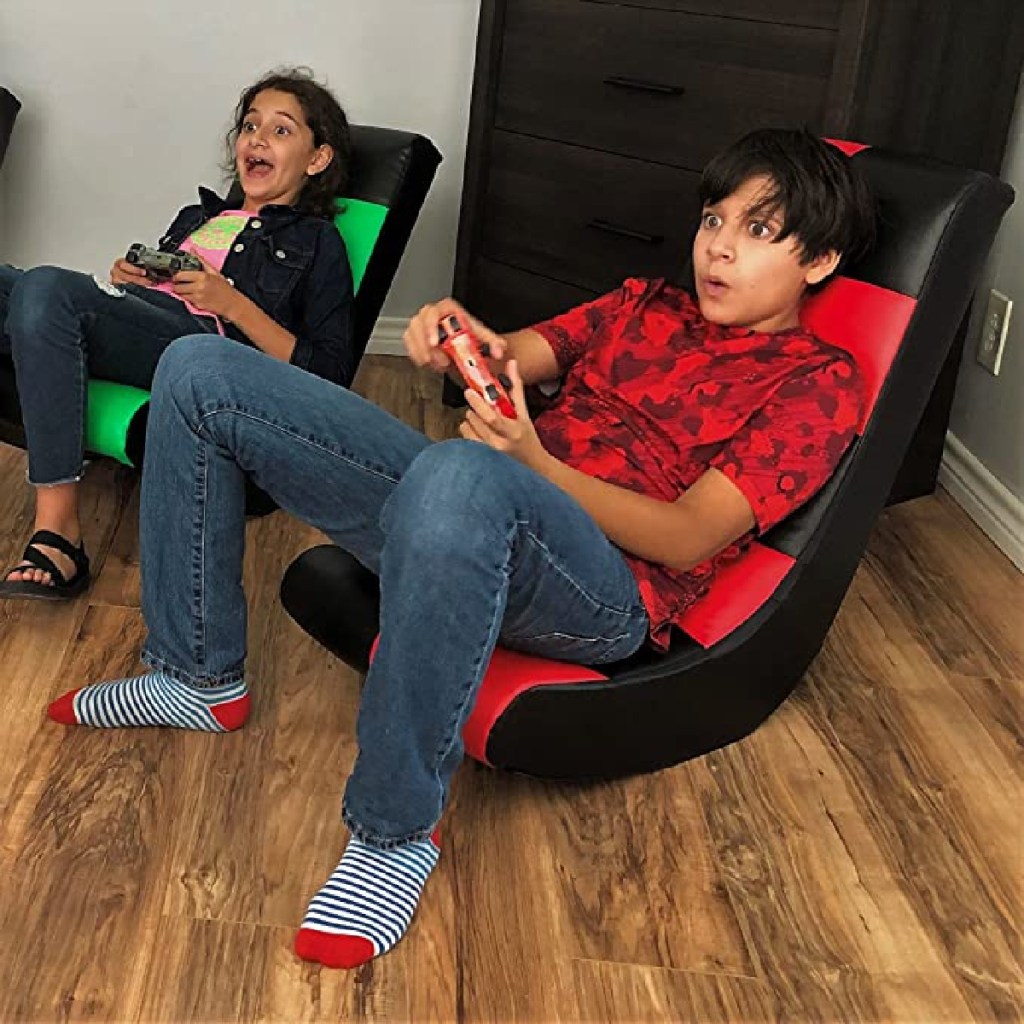 two kids playing video games on checkered gaming rockers