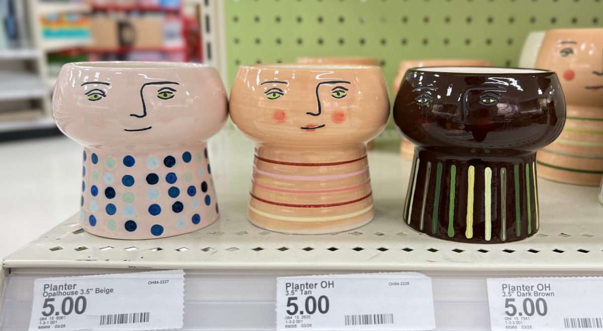 a row of planters from target that are designed to look like people