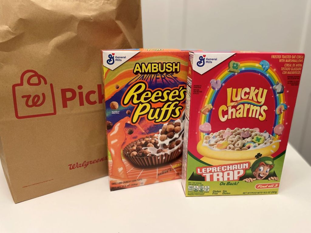 Box of Reese's Puffs and a box of Lucky Charms by a Walgreens bag